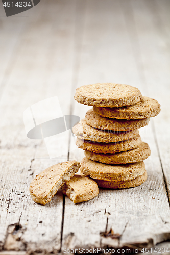 Image of Fresh oat cookies on rustic wooden table background. 