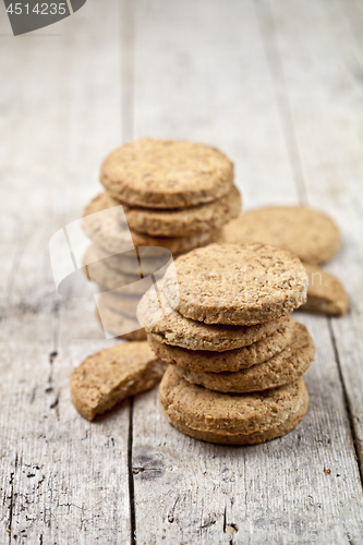 Image of Fresh oat cookies on rustic wooden table.