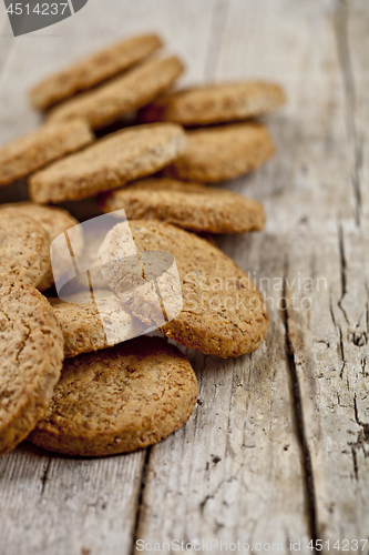 Image of Fresh oat cookies on rustic wooden table background.