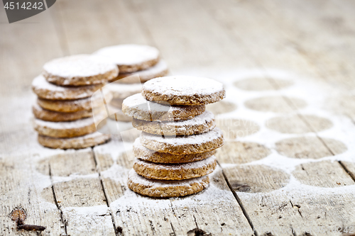 Image of Fresh oat cookies with sugar powder on rustic wooden table backg