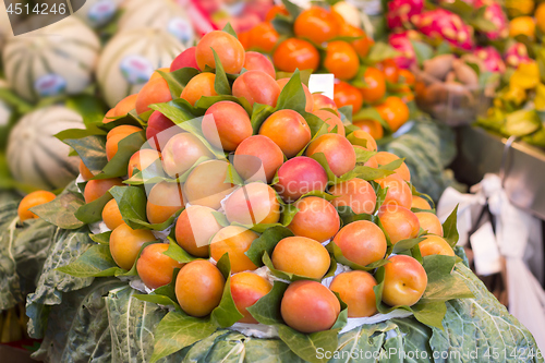 Image of Bunch of fresh apricots for sale in market