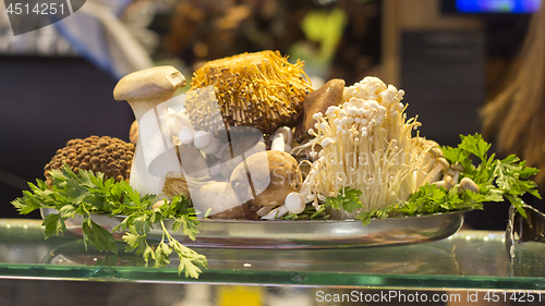 Image of Various types of mushrooms in a tin plate