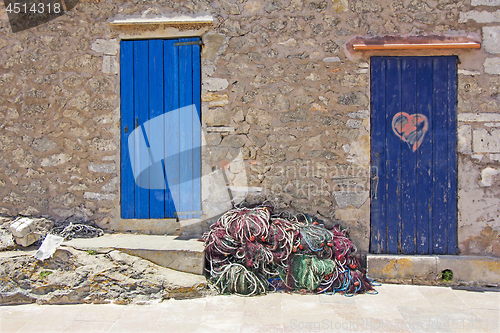 Image of Old wooden doors and fishing nets in Formentera 