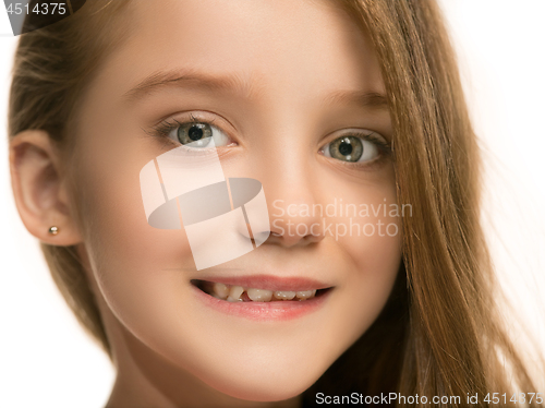 Image of The happy teen girl standing and smiling against white background.