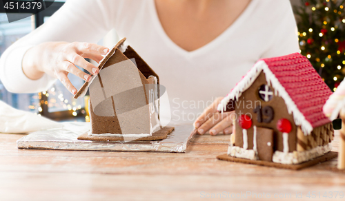 Image of close up of woman making gingerbread houses