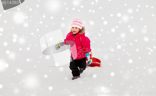 Image of little girl with sled on snow hill in winter