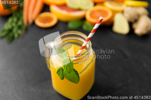 Image of mason jar glass of fruit juice on slate table top