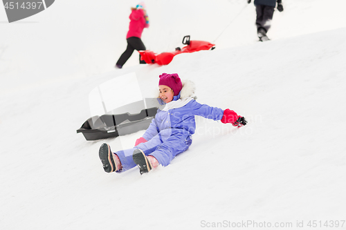 Image of little kids with sleds on snow hill in winter