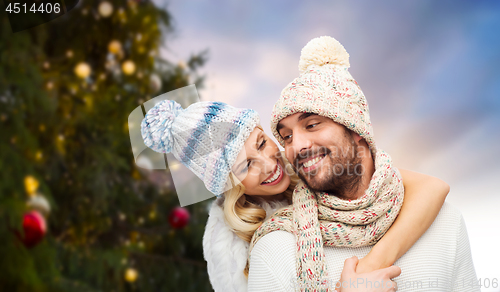 Image of happy couple hugging over christmas tree