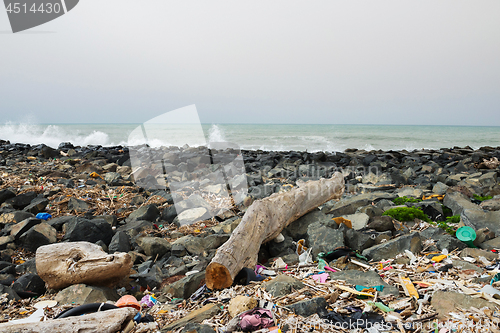 Image of Spilled garbage on the beach near the big city. Empty used dirty plastic bottles and other garbage. Environmental pollution. Ecological problem.