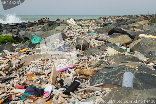 Image of Spilled garbage on the beach near the big city. Empty used dirty plastic bottles and other garbage. Environmental pollution. Ecological problem.