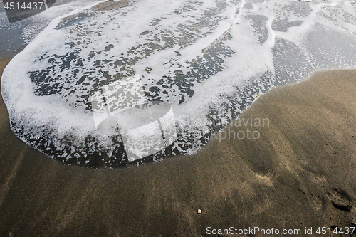 Image of Beautiful soft wave on black sand at the sea