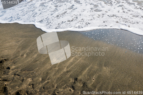 Image of Beautiful soft wave on black sand at the sea