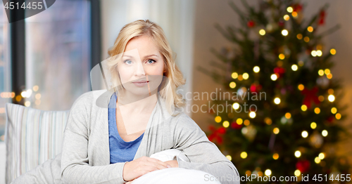 Image of middle aged woman over christmas thee lights