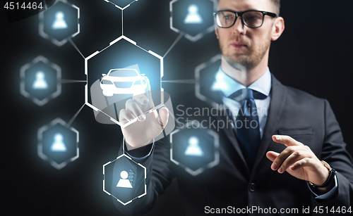 Image of businessman with virual hologram of car sharing