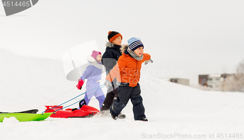 Image of happy little kids with sleds in winter