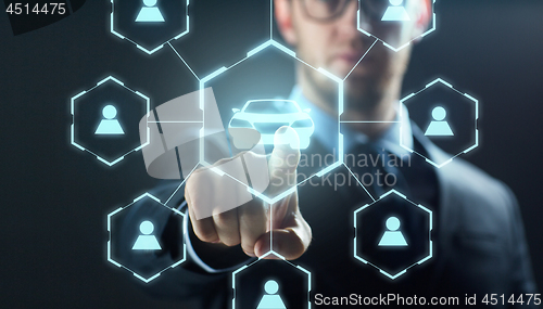 Image of businessman with virtual hologram of car sharing