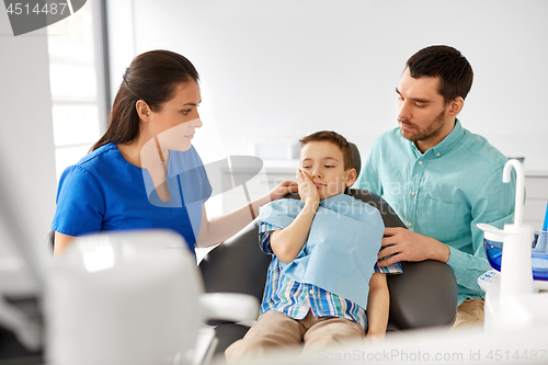 Image of father and son visiting dentist at dental clinic