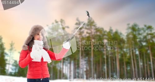 Image of happy woman taking selfie over winter forest