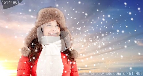 Image of happy woman in winter fur hat outdoors