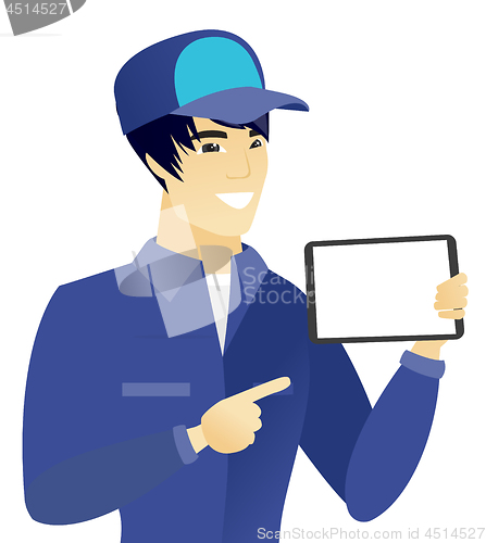 Image of Young asian mechanic holding tablet computer.