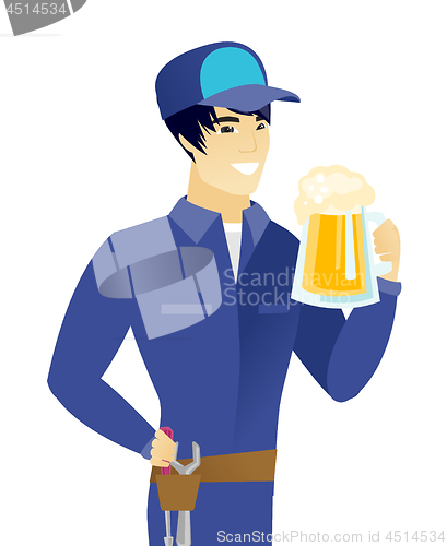Image of Young asian mechanic drinking beer.