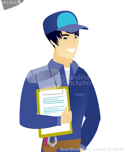 Image of Young asian mechanic holding clipboard with papers