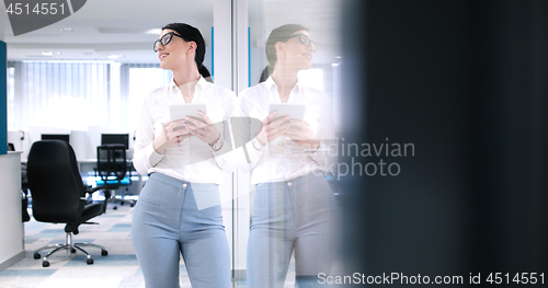 Image of Business Woman Using Digital Tablet in front of Office