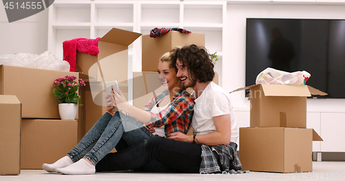 Image of young couple moving  in new house