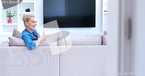Image of woman enjoying a cup of coffee
