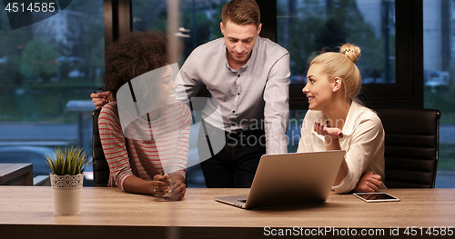 Image of Multiethnic startup business team in night office