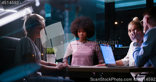Image of Multiethnic startup business team in night office