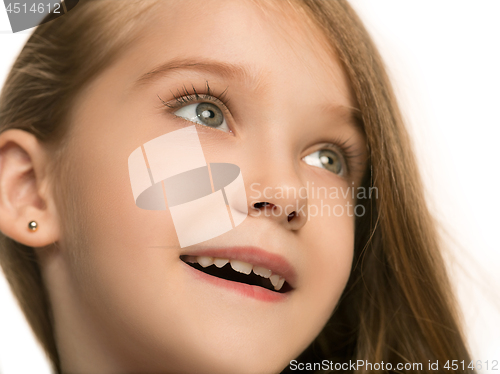 Image of The happy teen girl standing and smiling against white background.