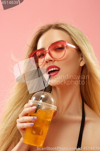 Image of Cute girls in swimsuits posing at studio. Summer portrait caucasian teenagers on pink background.