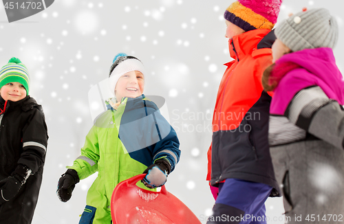 Image of happy little kids with sleds in winter