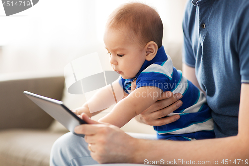 Image of baby and father with tablet pc at home