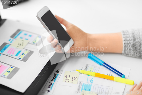 Image of web designer working on smartphone user interface