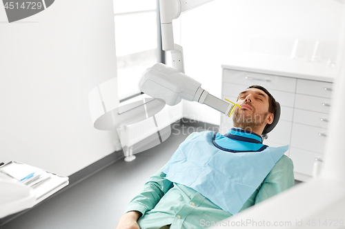 Image of patient having x-ray scanning at dental clinic