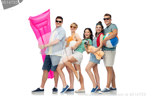 Image of happy friends with beach and summer accessories