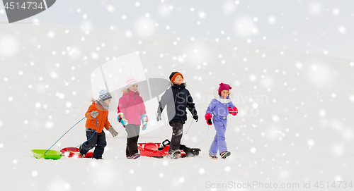 Image of happy little kids with sleds in winter