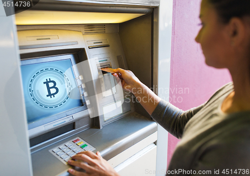 Image of close up of woman inserting card to atm machine