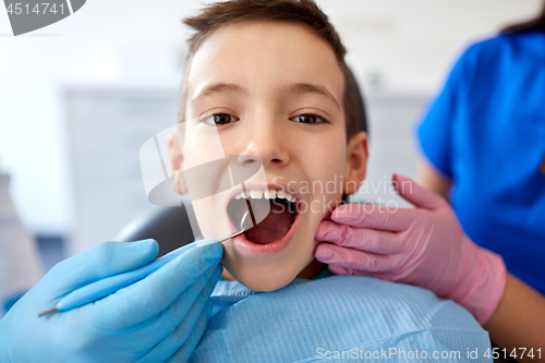 Image of boy having teeth checkup at dental clinic