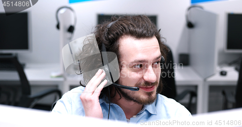 Image of male call centre operator doing his job