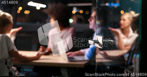 Image of Multiethnic startup business team in night office