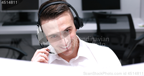 Image of male call centre operator doing his job