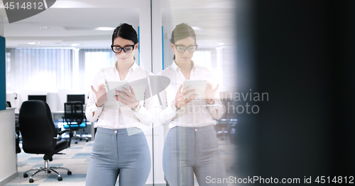 Image of Business Woman Using Digital Tablet in front of Office