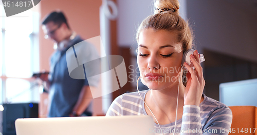 Image of businesswoman using a laptop in startup office