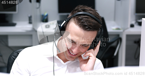 Image of male call centre operator doing his job