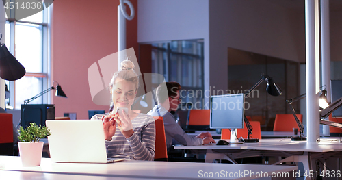 Image of businesswoman using a laptop in startup office