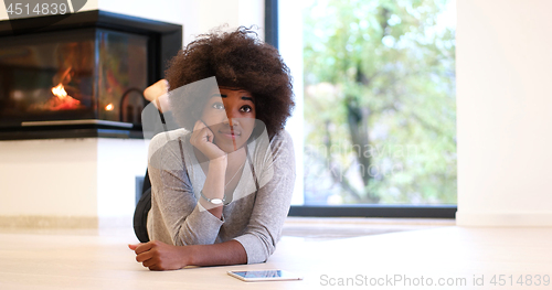 Image of black women using tablet computer on the floor